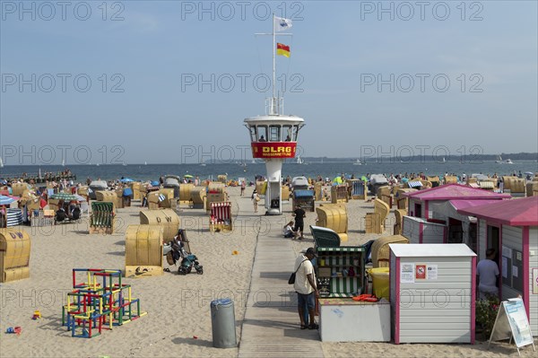 Summer weather, bathers, beach chairs and DLRG lifeguard tower on the beach, Travemünde beach,