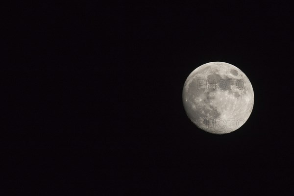 Waxing gibbous Moon, landscape orientated image with Moon isolated on black background with text or