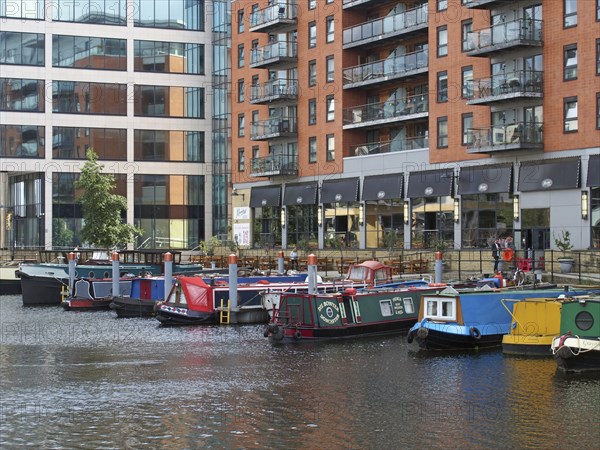 Leeds, west yorkshire, united kingdom, 16 july 2019: a view of of leeds dock houseboats and barges