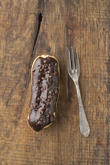 Eclair with chocolate ganache with cocoa nibs topping