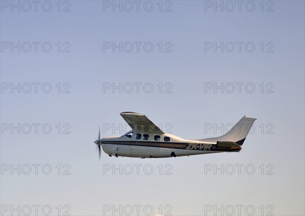 Single engined light aircraft flying over Westland, New Zealand, Oceania