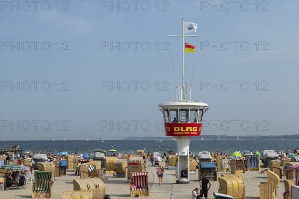Summer weather, bathers, beach chairs and DLRG lifeguard tower on the beach, Travemünde beach,