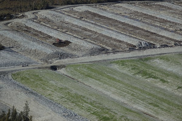 Diggers excavating land to make humps and hollows for farmland, West Coast, South Island, New