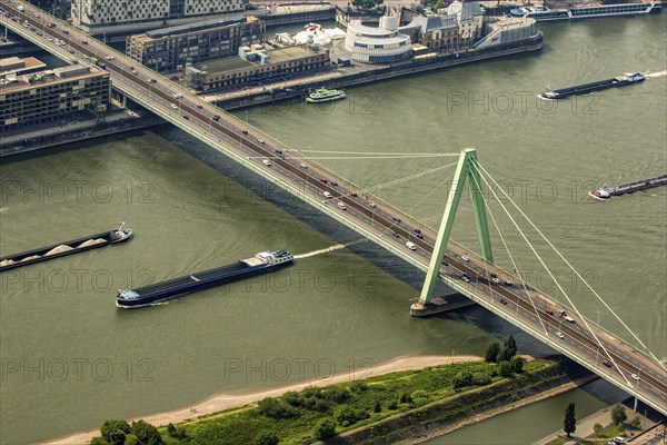 Ships on the Rhine pass under the Severin Bridge. Cargo ships, inland navigation