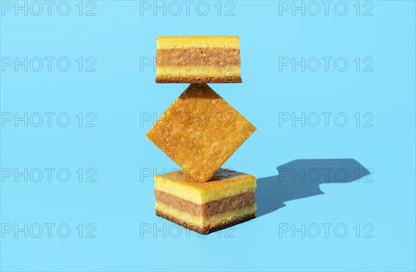Homemade apple cake in bright light, minimalist on a blue table. Slices of apple cake in an