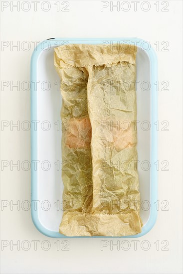 Green asparagus with salmon to bake with baking paper in a baking dish