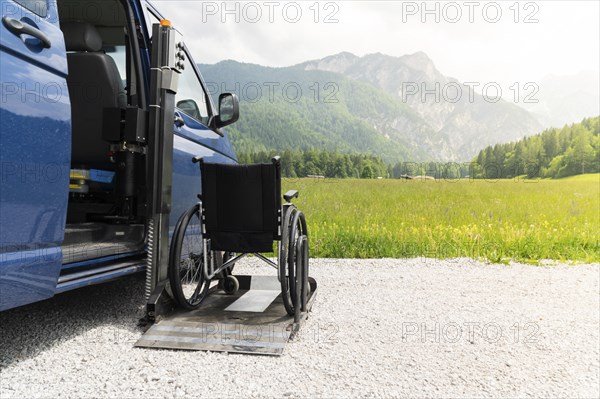 Photo of black electric lift specialized vehicle for people with disabilities. Empty wheelchair on