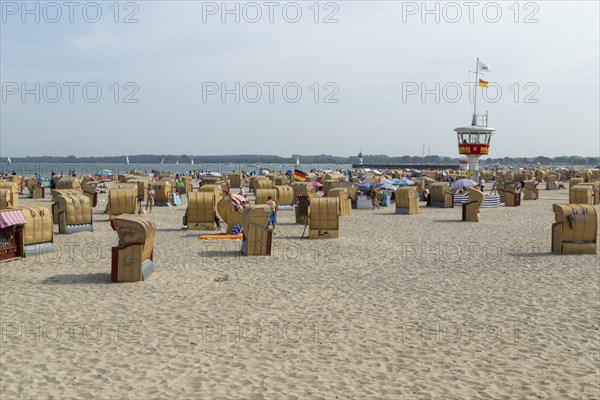 Summer weather, bathers, beach chairs and DLRG lifeguard tower on the beach, Travemünde beach,