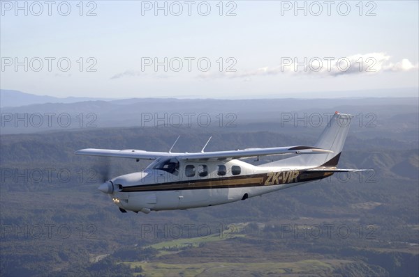 Single engined light aircraft flying over Westland, New Zealand, Oceania