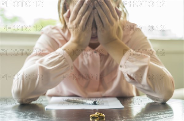 Great concept of divorce, end of relationship, sad young woman, signing divorce agreement, with