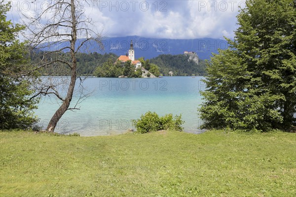 Lake Bled Slovenia. Beautiful mountain lake in summer with small Church on an island with castle on