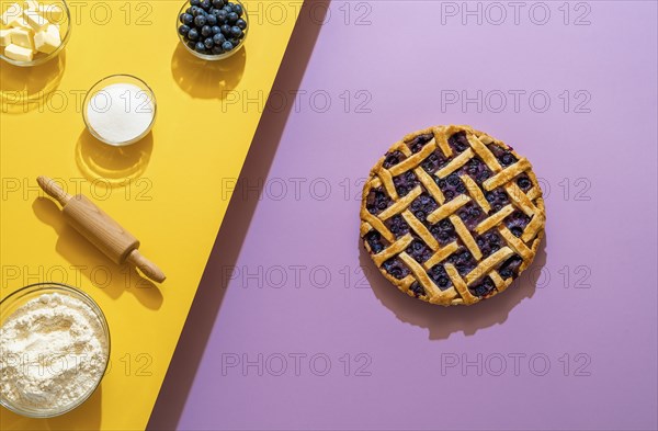 Making a blueberry pie from scratch with butter, sugar, flour, and fruits, on a seamless background
