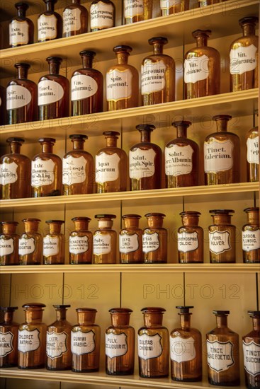 Enkhuizen, Netherlands, June 2022. Shelves with glass jars containing ingredients for medicine.