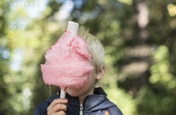 Pink candy floss in front of a kid
