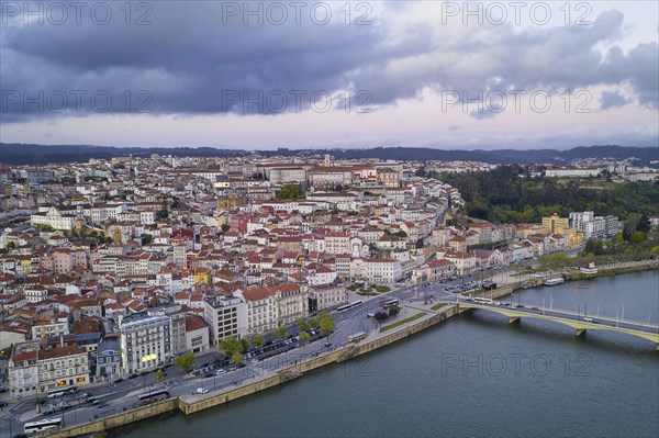 Coimbra drone aerial city view at sunset with Mondego river and beautiful historic buildings, in