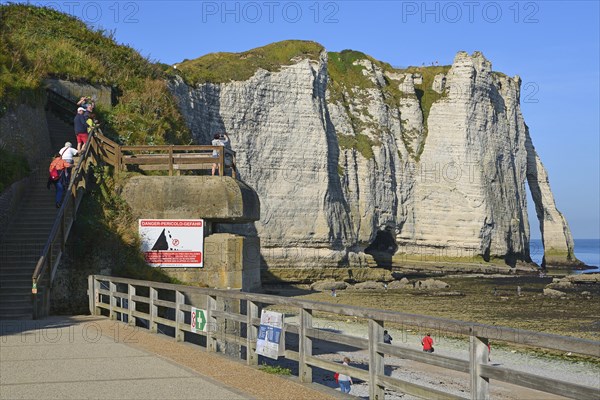 Tourist on the way to the cliffs, german bunker, morning sun