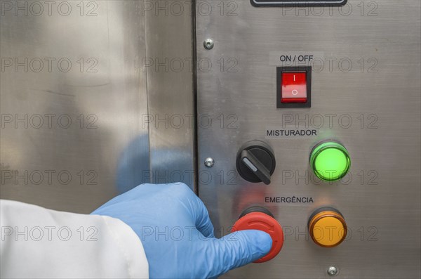Great concept of emergency, person pushing the emergency button of production equipment