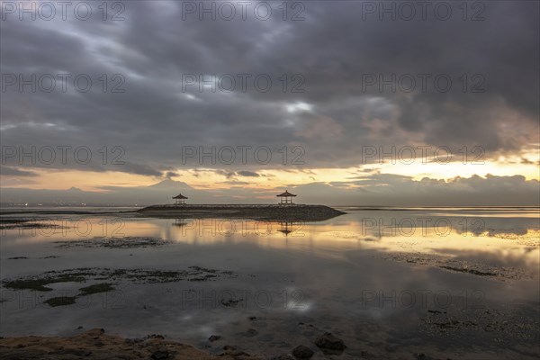 Beautiful seascape in the morning. Tropical sandy beach with breakwater and reflection of the sky