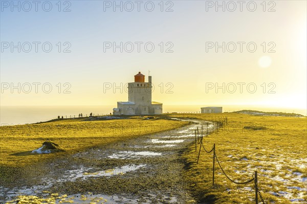 Famous lighthouse at sunset on Dyrholaey beach in Iceland in cold winter, near Vik