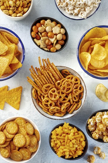 Salty snacks, party mix. A variety of crispy appetizers, shot from the top. Tortilla and potato