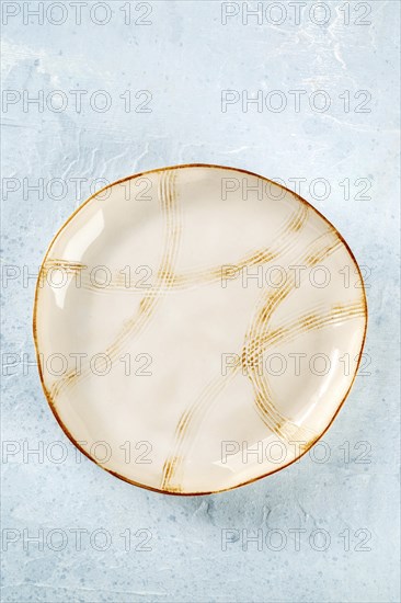 An empty plate with a gold rim, top shot on a slate background, the concept of food, Food
