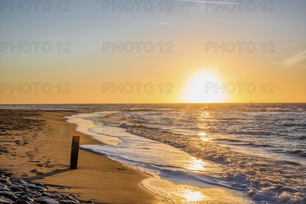Den Helder, Netherlands. January 2022. Setting sun on the beach of Den Helder, Netherlands.