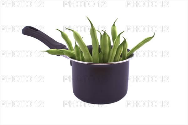 A handful of green beans in the pot isolated on white background. Healthy, nutritious vegetarian