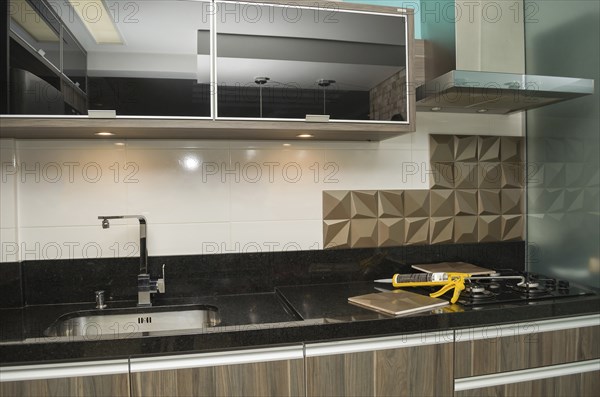 Renovating the kitchen, installing tile on the wall