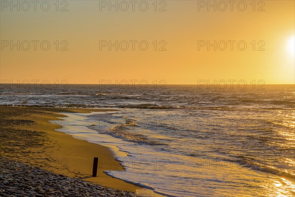 Den Helder, Netherlands. January 2022. Setting sun on the beach of Den Helder, Netherlands.