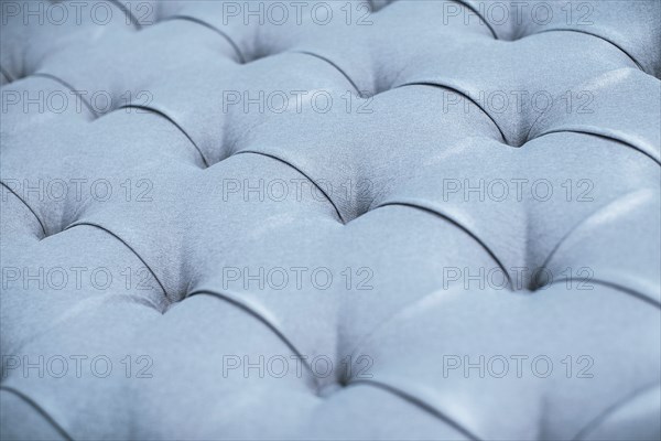 Blue gray upholstered furniture from ement quilted fabric texture. Interior design, headboards made
