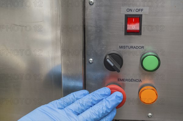 Great concept of emergency, person pushing the emergency button of production equipment