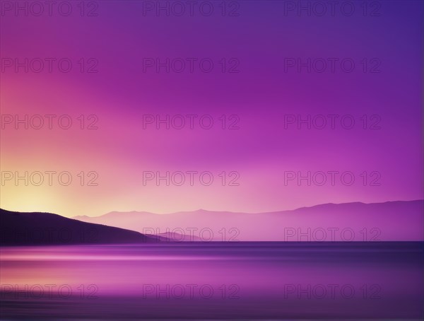 Calm sunset with a gradient sky over mountains and water in purple and pink hues, AI generated