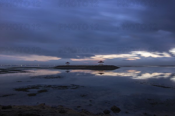 Beautiful seascape in the morning. Tropical sandy beach with breakwater and reflection of the sky