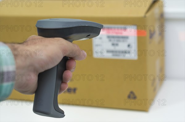 Great concept of traceability, ERP system, hand crawling product barcode and packaging. The man