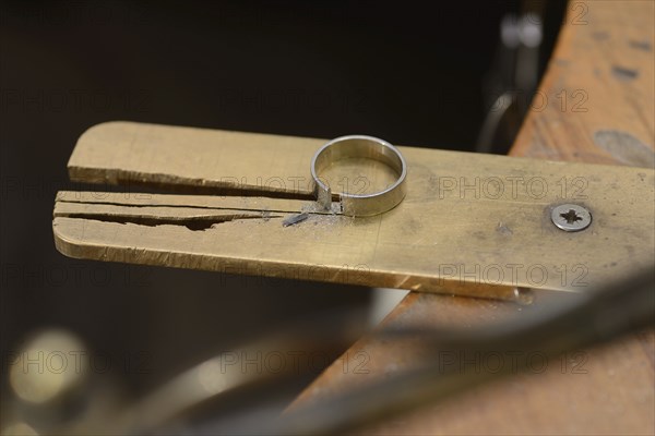 A gold ring cut and ready to be made smaller