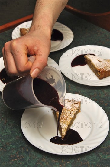 Cooks adding sauce to delicious homemade apple pies