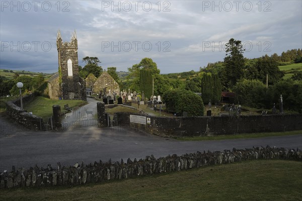 A view of the Church and graveyard near St Gobnait's well in Cúil Aodha in West Cork on a sunny
