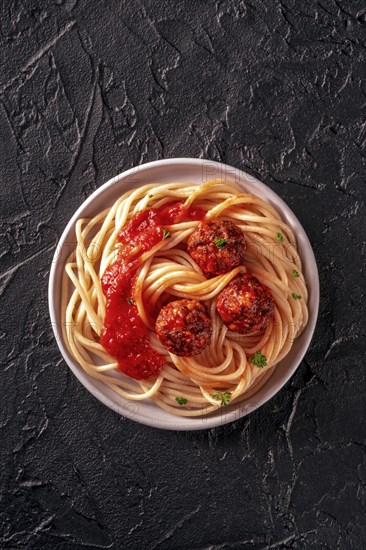 Meatballs. Beef meat balls, shot from above with spaghetti pasta, parsley, and tomato sauce, on a