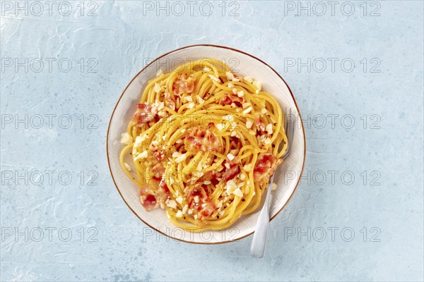Carbonara pasta dish, traditional Italian spaghetti with pancetta and cheese, overhead flat lay