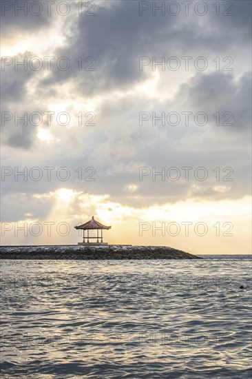 Beautiful seascape in the morning. Tropical sandy beach with breakwater and reflection of the sky