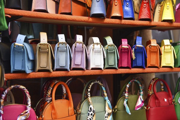 Florence, Italy. September 2023. Souvenir stalls with colorful handbags in Florence