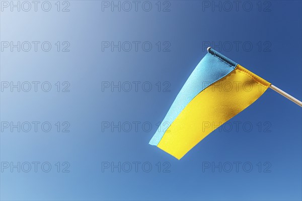 Large bicolor yellow blue Ukrainian state flag, national symbol fluttering, waving in wind against