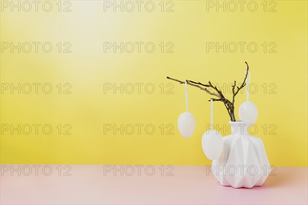 Happy Easter holiday, coming spring concept. Tree branches, flower twigs in white vase or jar with