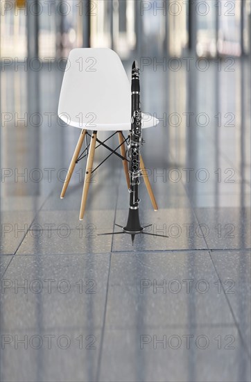 Clarinet and a white chair in an auditorium