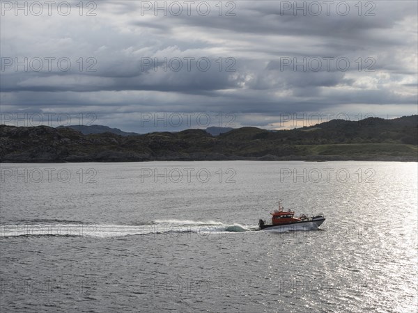 A pilot boat sails along the Norwegian coast