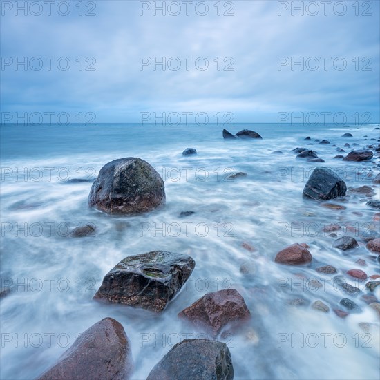 Stormy Baltic Sea in winter, boulders in the surf, near Rerik, Mecklenburg-Western Pomerania,
