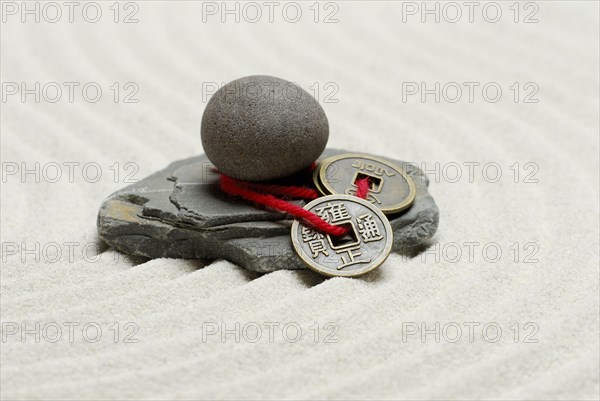 Stones and Chinese lucky coins, coins, lucky coins, lucky coin, coin, in sand