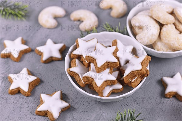 Bowl with traditional German cinnamon star Christmas cookies called 'Zimtsterne' made with almonds,