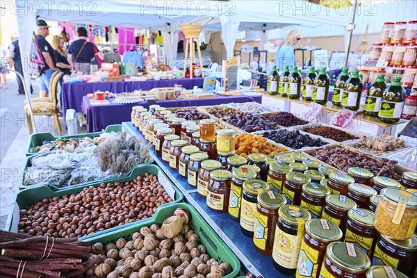 Market stall with honey und nuts and vegetables on a weekle market near Tarragona, Catalonia,