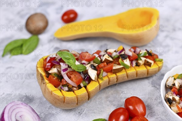 Vegan baked Butternut squash vegetable filled with bell pepper, cherry tomatoes, red onion and
